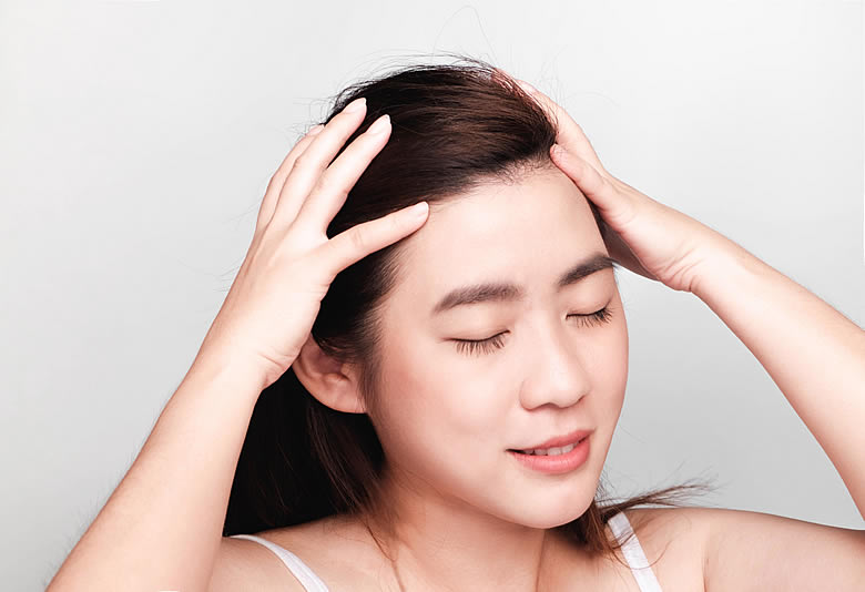Woman Massaging Her Head
