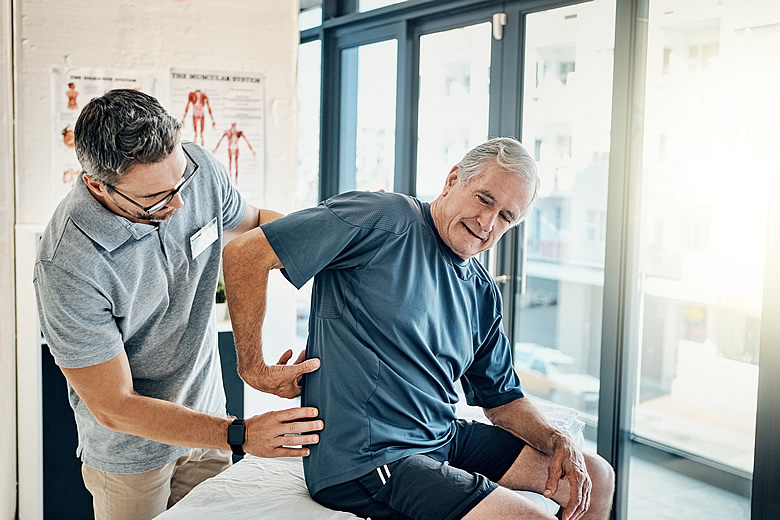 Man Being Examined for Back Pain
