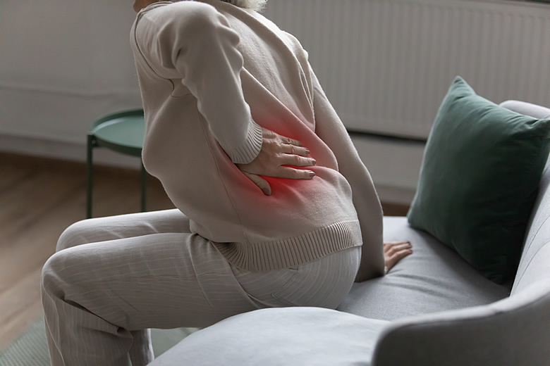 Woman on Couch with Back Pain