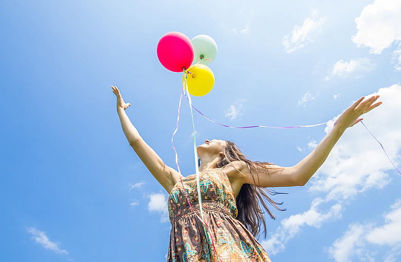 Woman Releasing Balloons