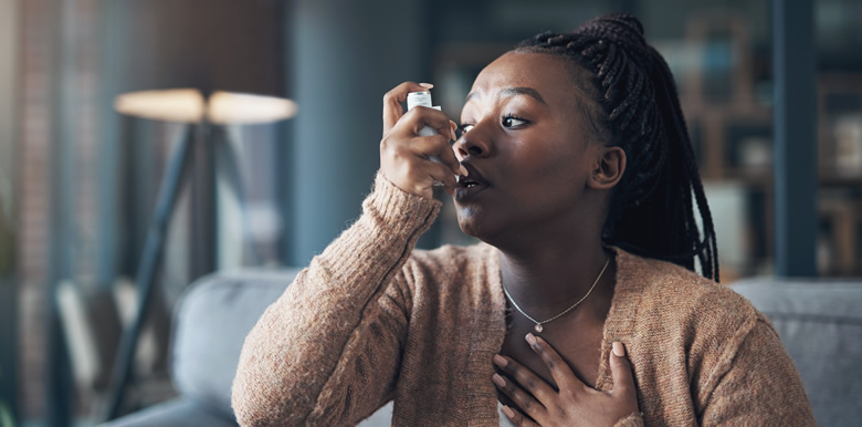 Woman Using an Inhaler