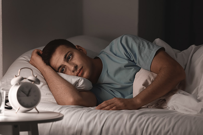 Young man unable to fall asleep